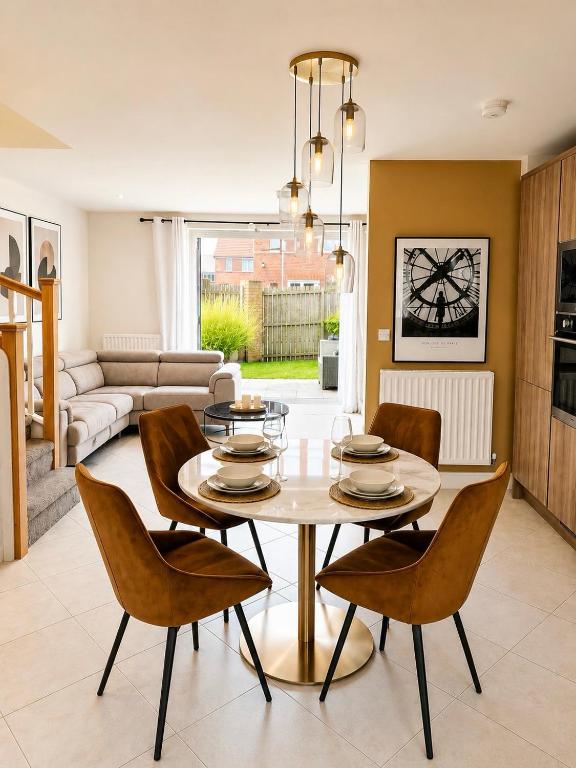 a dining room with a table and chairs at Mason Gardens Home in Chilton