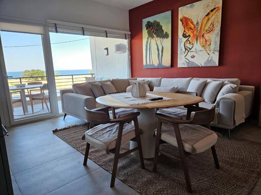 a living room with a table and a couch at Like home in Samothraki 2 in Kamariotissa
