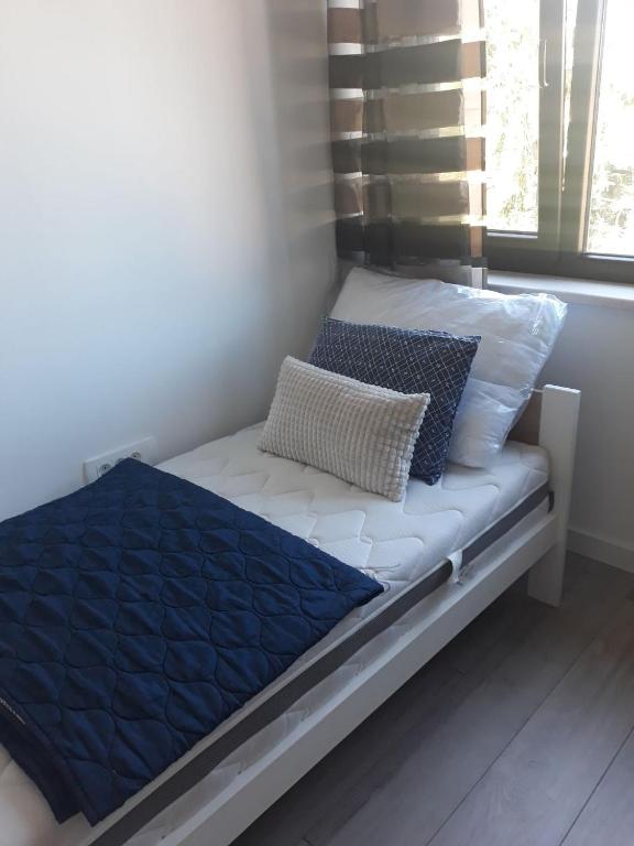 a bed with blue and white pillows on it at Eco-Luxury Suite Luna in Umag