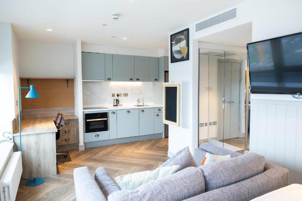 a living room with a couch and a kitchen at The Parade - Cardiff - 10 Min Walk to City Centre in Cardiff