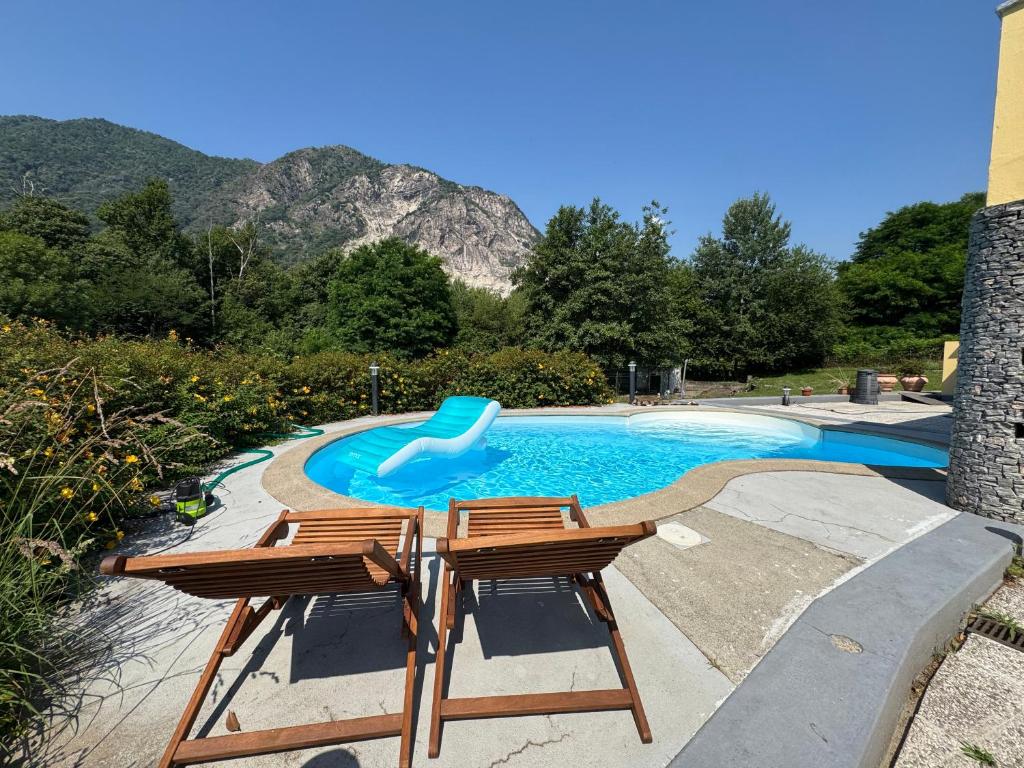 a swimming pool with two chairs and a slide at Il Ranch in Baveno