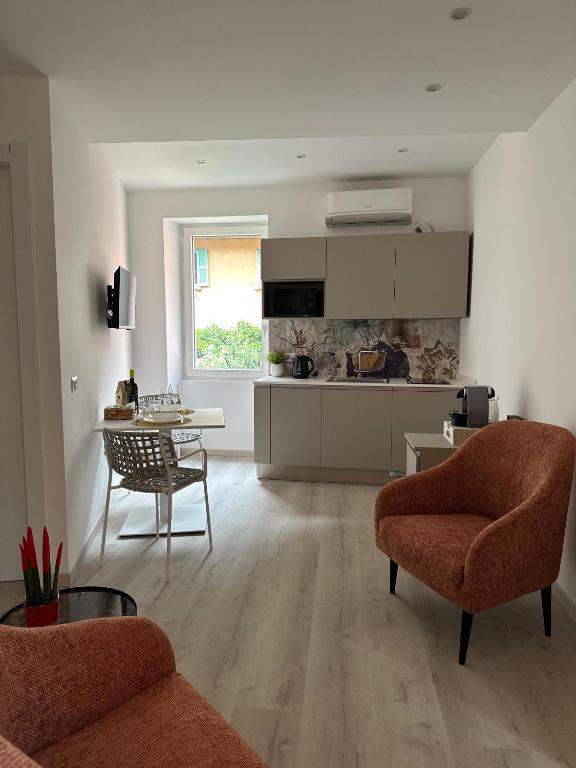 a kitchen and living room with a table and chairs at Dimora di Aida Lugano Lake in Porlezza