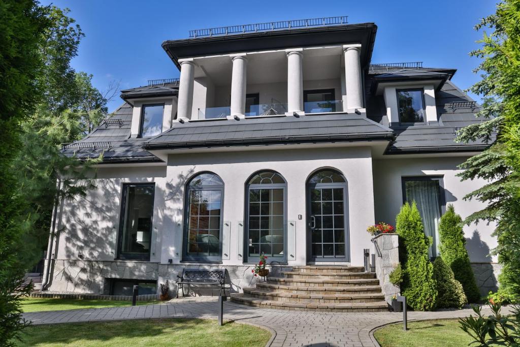 a large white house with columns at Villa 33 in Zakopane