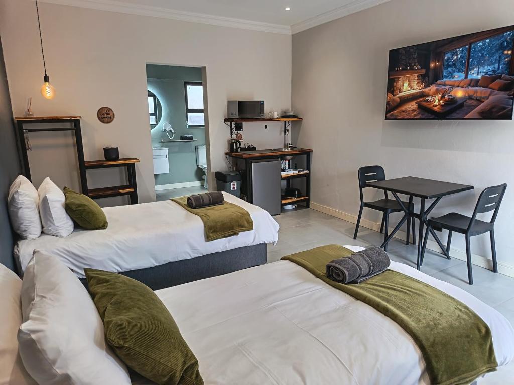 a hotel room with two beds and a table at Unit 7 Dinas Accommodation Oranjemund in Oranjemund