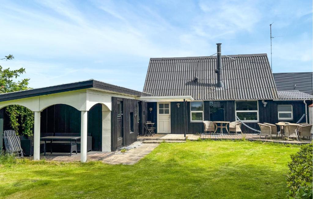 a house with a green yard with a house at 3 Bedroom Pet Friendly Home In Roslev in Roslev