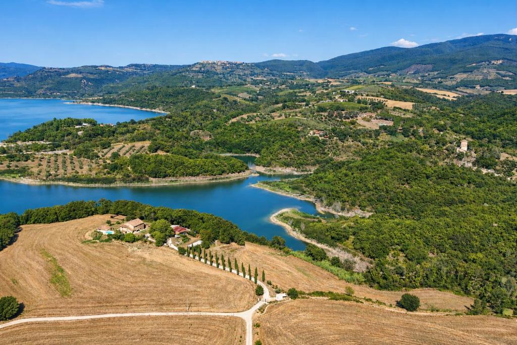 an aerial view of a lake and a farm at SCAPPO IN UMBRIA, casale al lago in Corbara