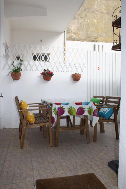 a patio with two chairs and a table with pillows at Casa da Avenida in Cascais