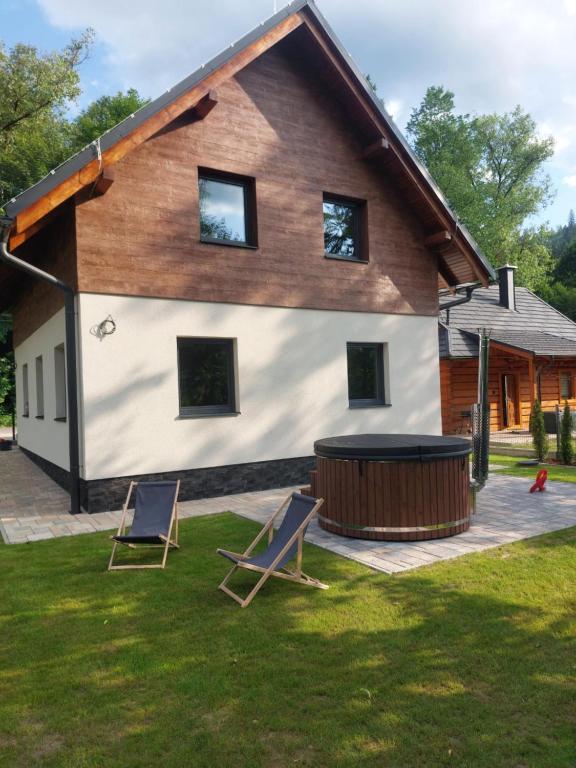 a house with two chairs and a hot tub at Oščadnica, Tadorka in Čadca