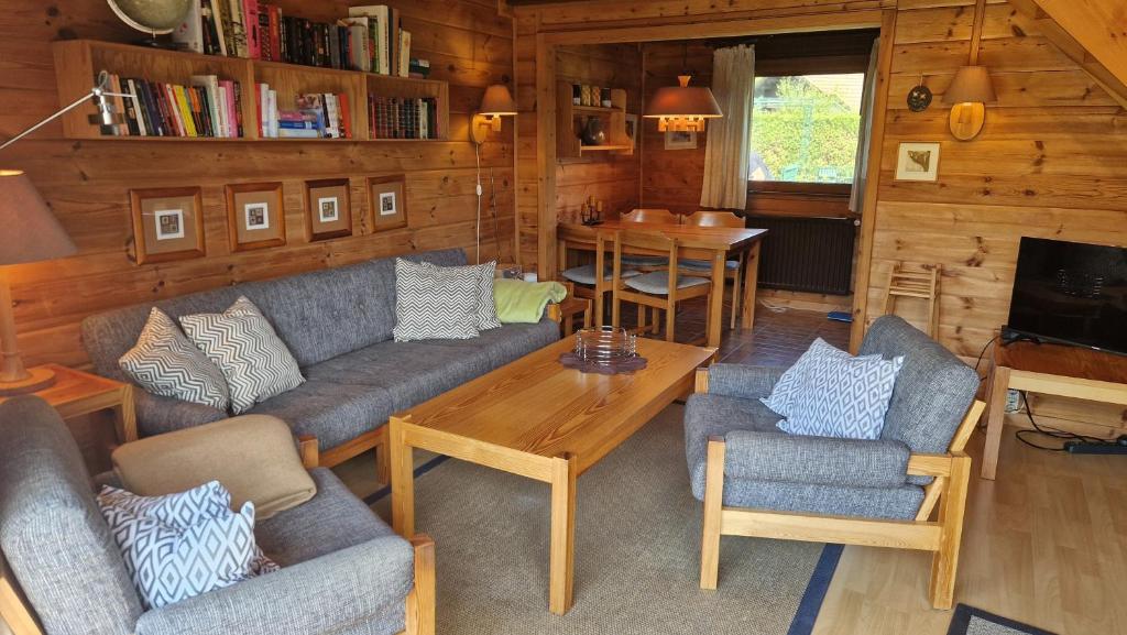 a living room with a couch and chairs and a table at Feriennest Buendorf in Dahlenburg