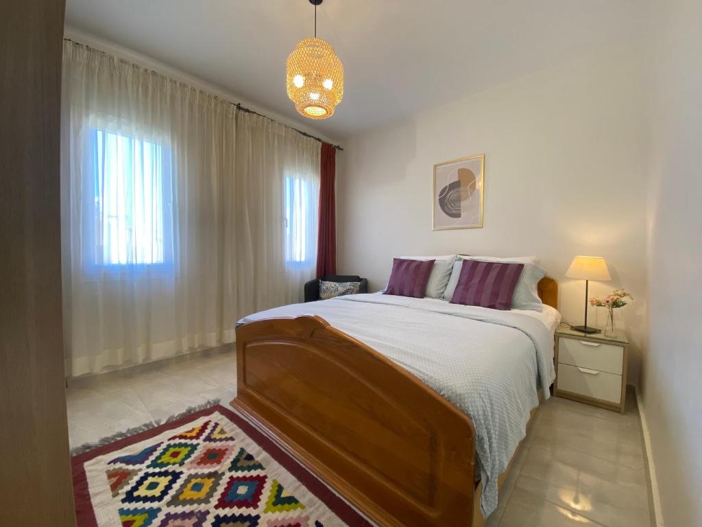 a bedroom with a large bed and a window at Mountain View luxe chalet Ras elhikma families only in Ras Elhekma