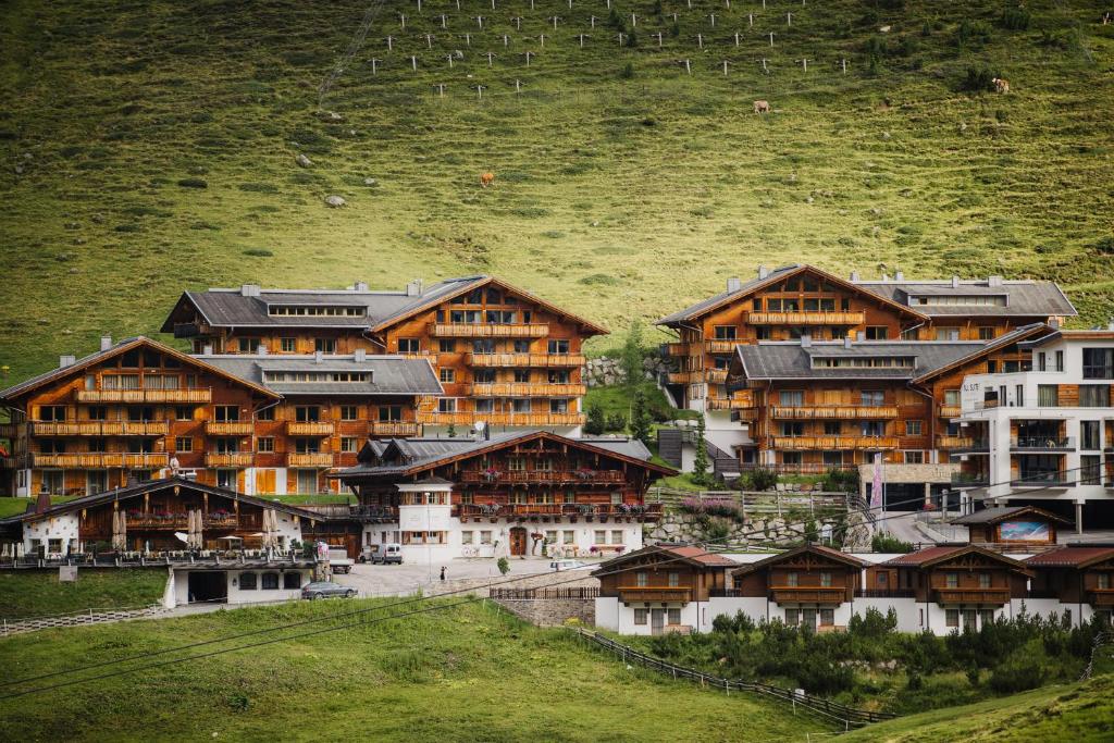 a group of buildings sitting on top of a hill at AlpinLodges Kühtai in Kühtai