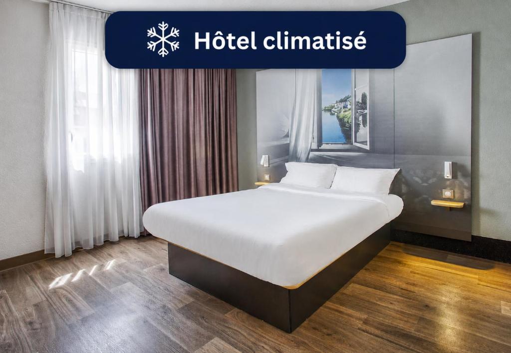 a large bed in a room with a hotel climate sign at B&B HOTEL Angoulême in Le Gond-Pontouvre