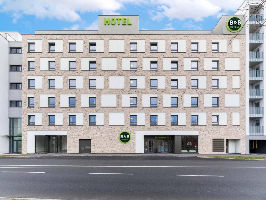 a large brick building with a hotel sign on it at B&B HOTEL St-Pölten in Sankt Pölten