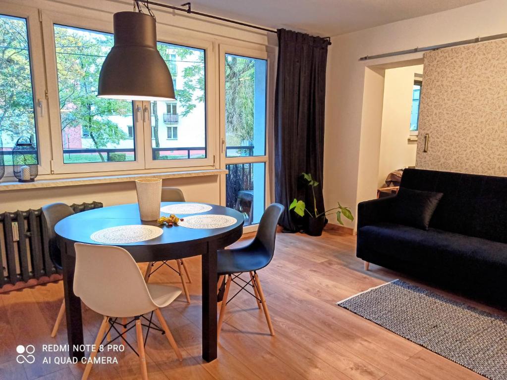 a living room with a table and chairs and a couch at Studio Park Śląski Katowice/Chorzów in Chorzów