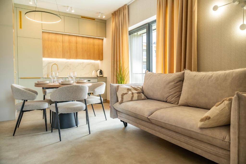 a living room with a couch and a table at Apartament K&M 13 in Mikołajki
