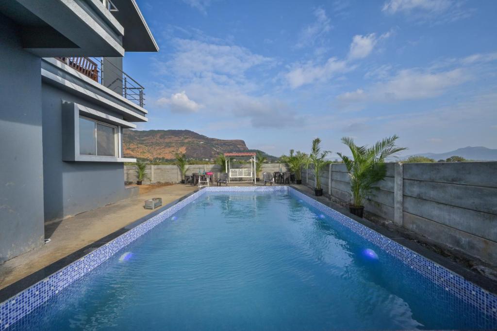 a swimming pool in the middle of a building at II EMPYREAN STAYS II LEONCINO VILLA II 4BHK II LARGEST SWIMMING POOL II AC Il in Lonavala
