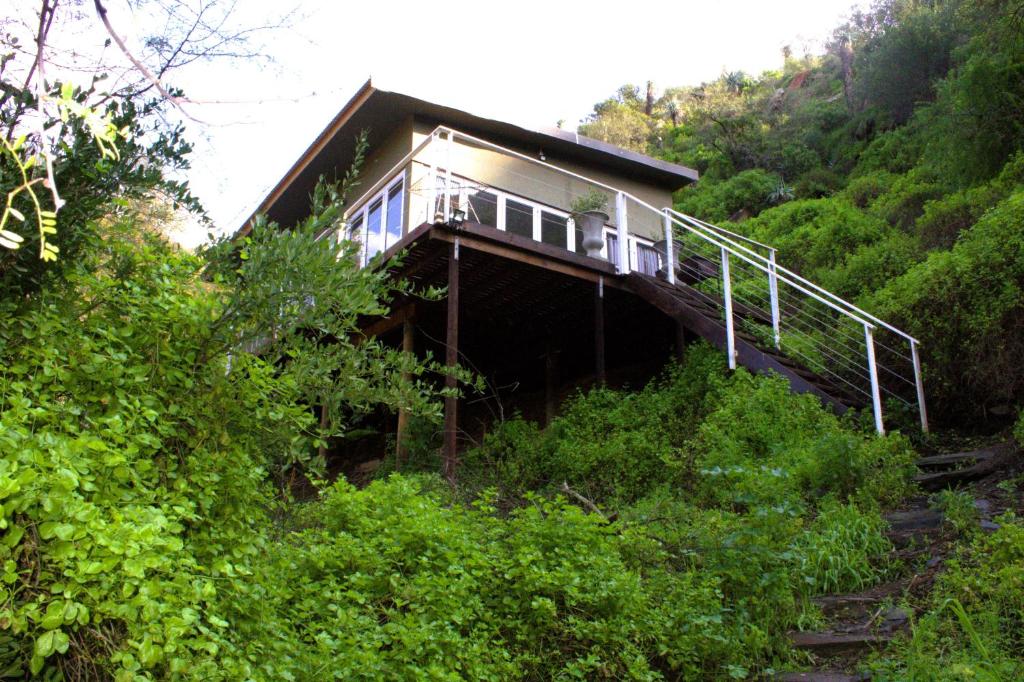 a house on a hill in the middle of a forest at Hangman's Lookout in Calitzdorp