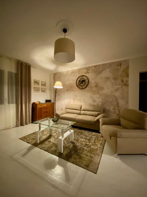 a living room with a couch and a table at La Lidia in Sassari