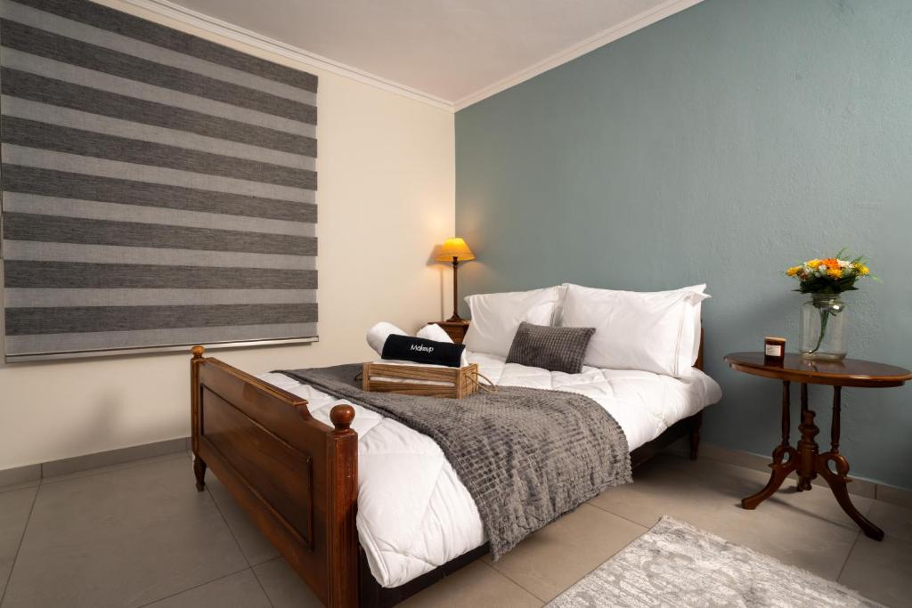 a bedroom with a bed with a laptop on it at Karydeones Living in Kleidoniá