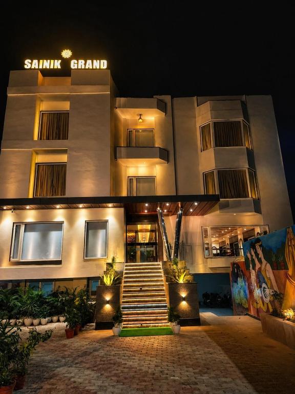a building with stairs in front of it at night at Hotel Sainik Grand in Varanasi