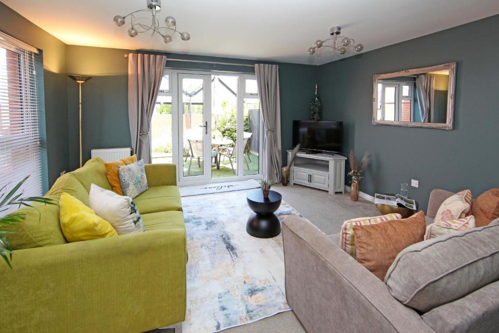a living room with two couches and a television at Autumn Heights Apartments in Telford