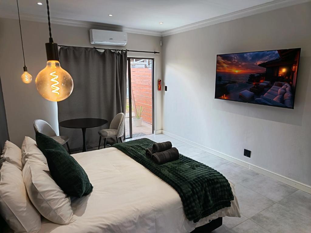a bedroom with a large bed with a tv on the wall at Unit 9 Dinas Accommodation Oranjemund in Oranjemund