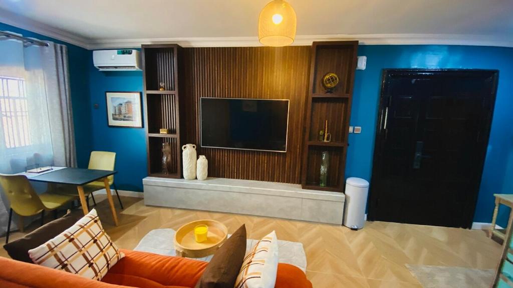 a living room with a couch and a television at One Bedroom, Double bed and one sofa bed in Iseri