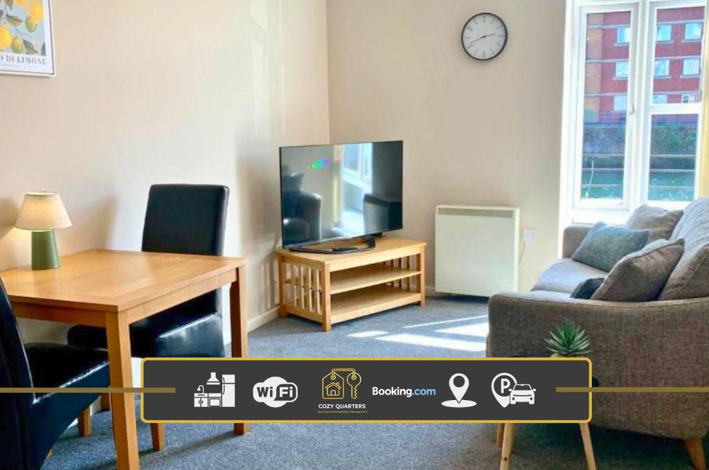 a living room with a tv and a couch and a table at 1 Bed Apartment By Cozy Quarters Property Management Short Term Lets Hartlepool Near Beach in Hartlepool