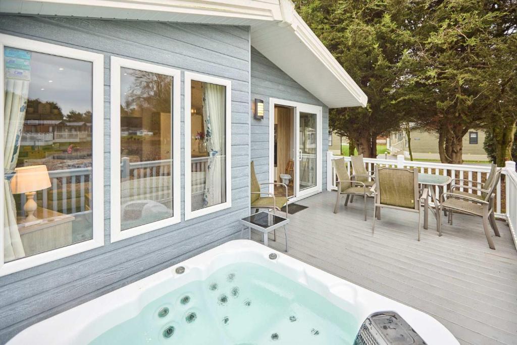 a jacuzzi tub on the back of a house at The Haven Lodge with Hot Tub in York