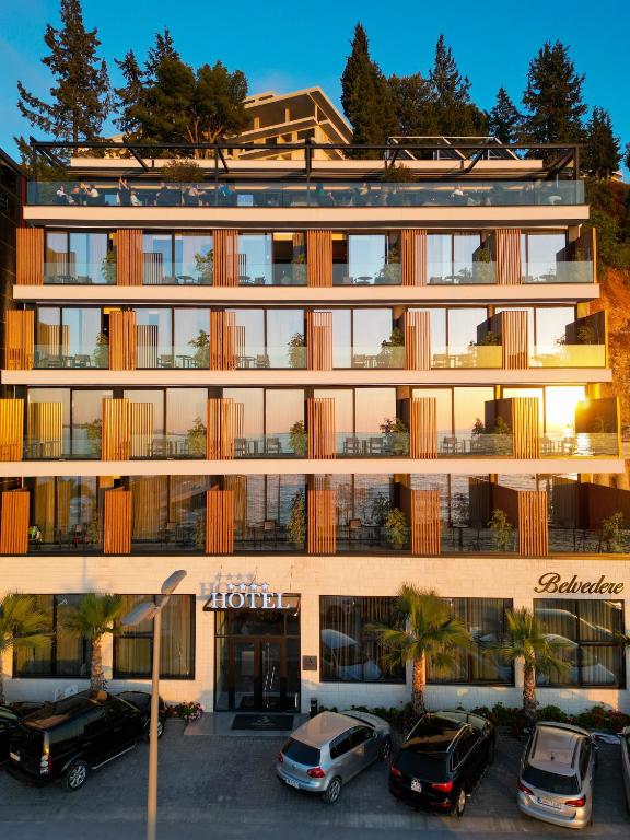 a building with cars parked in front of it at Belvedere Hotel in Vlorë