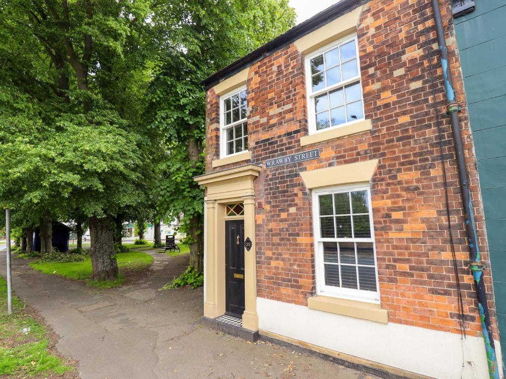 a brick building with a door on a street at 35 Wrawby Street in Brigg