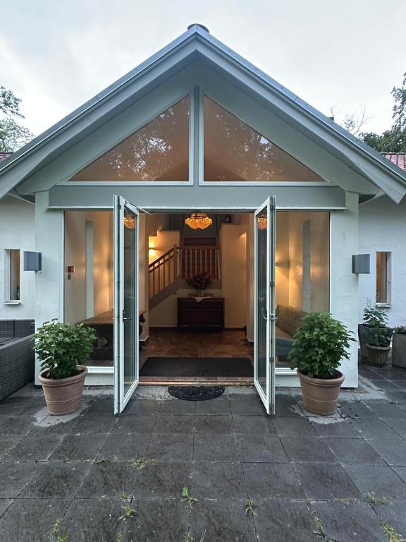 a house with sliding glass doors on a patio at Kronovall Park Residence in Skåne-Tranås
