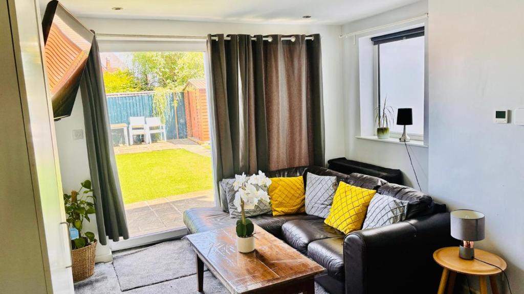 a living room with a couch and a table at Sleeps 5 Free Parking Fast WiFi Near Hillsborough Easy Access to Sheffield City Centre and Peak District in Hillsborough