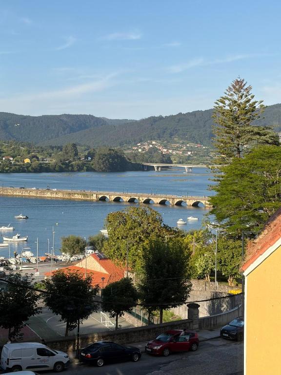 a view of a river with boats in the water at A Casa do Miradoiro in Puentedeume