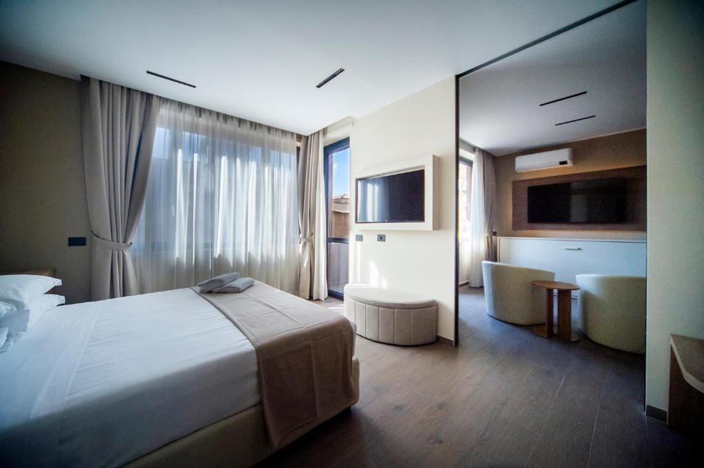 a hotel room with a bed and a large mirror at Sant'Angela Rooms in Foligno