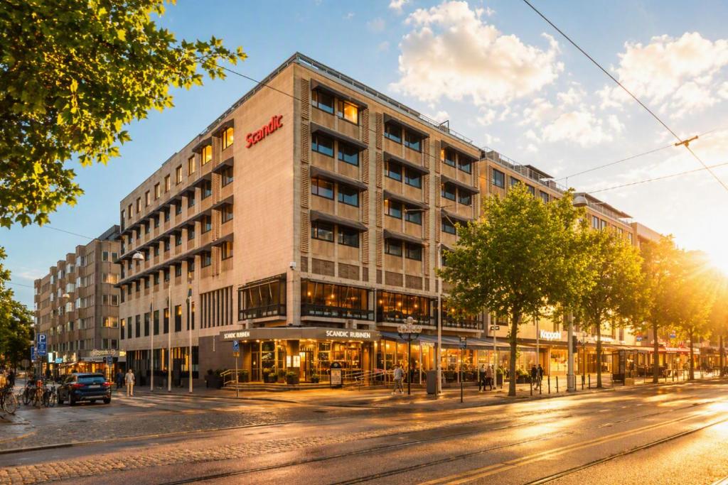 a large building on a street with a street at Scandic Rubinen in Gothenburg