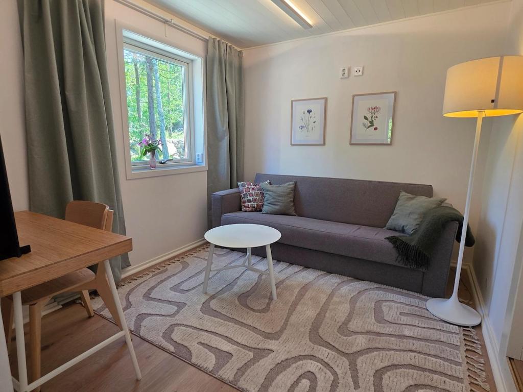 a living room with a couch and a table at Lyckebo in Tyresö