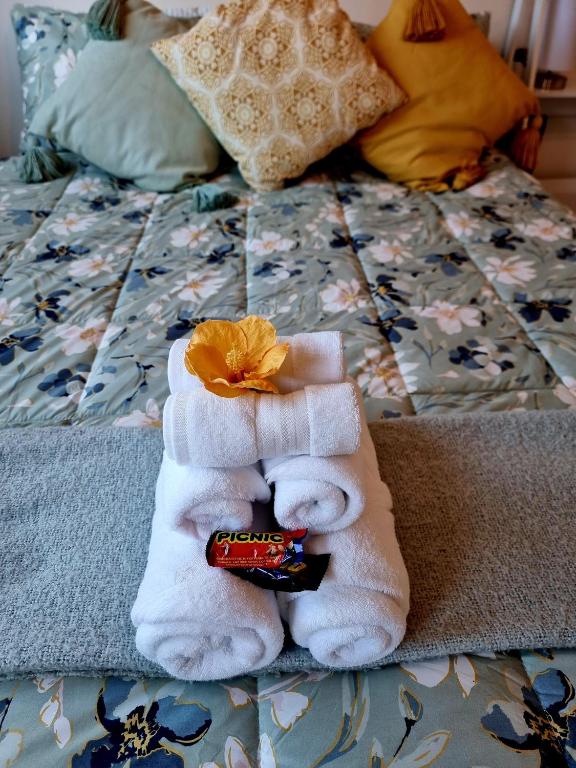 a pile of towels sitting on top of a bed at Sun Republik Studio in Whitianga