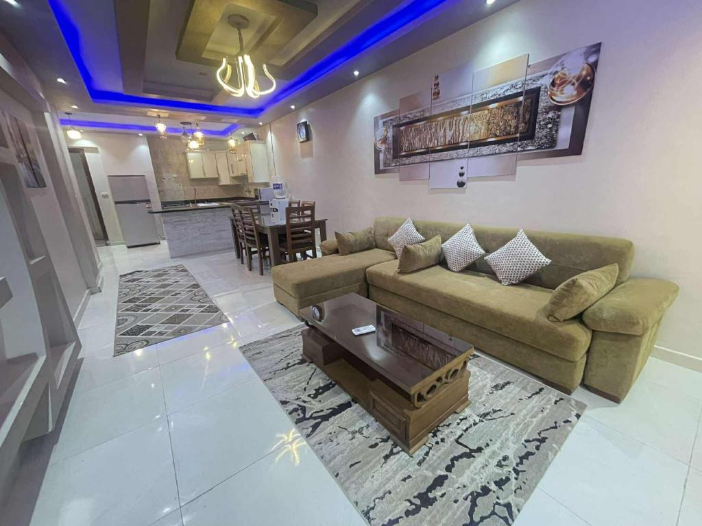 a living room with a couch and a table at شاليه مارسليا بيتش in Dawwār Muḩammad Abū Shanab