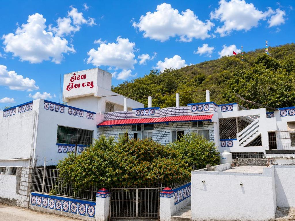 a white building with a sign on top of it at Hotel HillView, Junagadh in Junagadh
