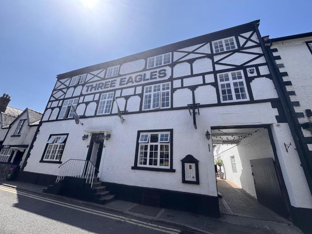 a large white building with a three eagleagles sign on it at Three Eagles Hotel&Restaurant and Garden Bar in Llangollen