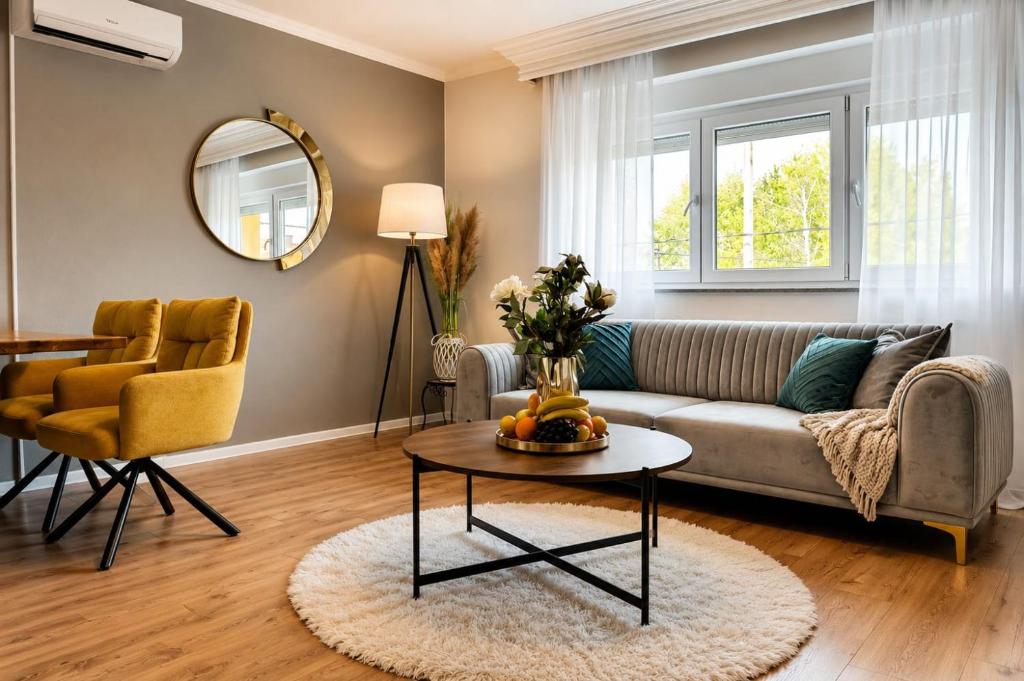 a living room with a couch and a table at Elite Apartment Jasmina in Bihać