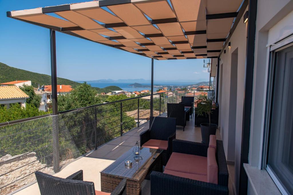 a balcony with a table and chairs and a view at PERDIKA's HORIZON in Perdika