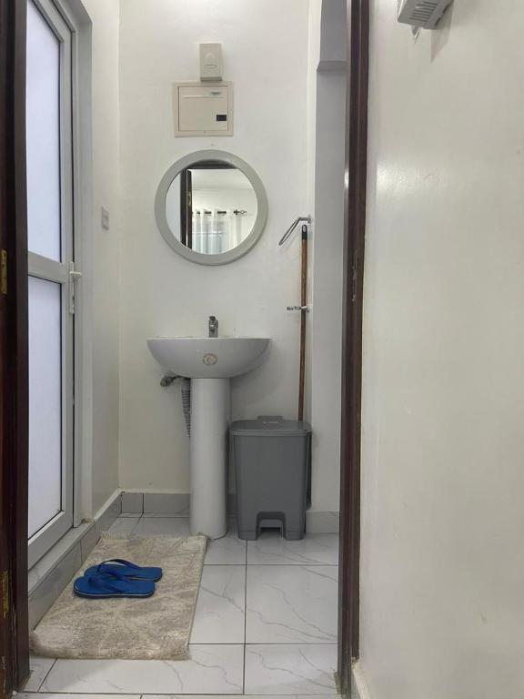 a bathroom with a sink and a mirror at Bellah Homes in Bamburi