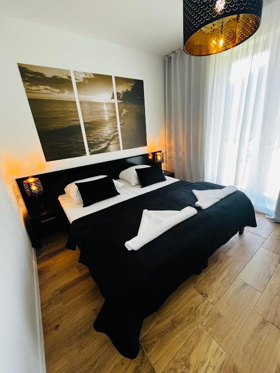 a bedroom with two beds with black and white pillows at Tesao Room by Dworek Marino in Grzybowo