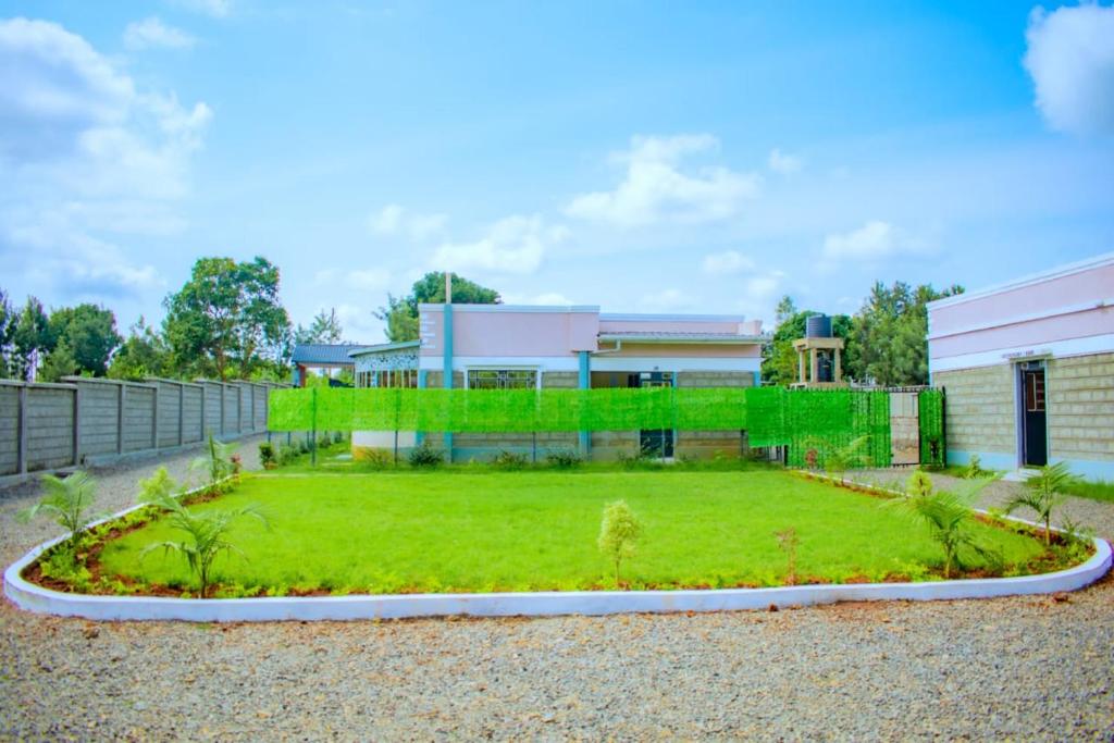 a house with a garden in front of it at theSuperblane Resort in Sagana
