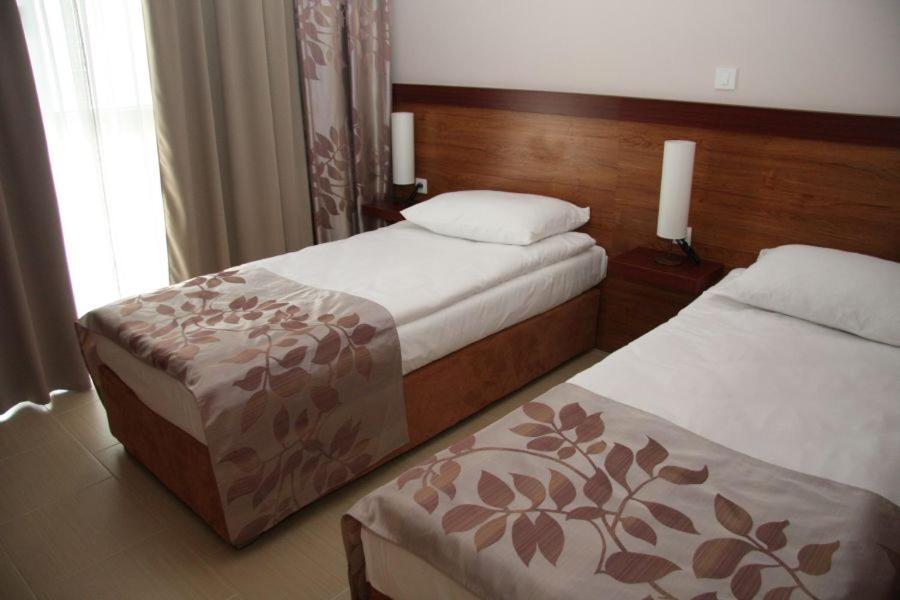 a hotel room with two beds and a window at Hotel Aquapark Žusterna in Koper