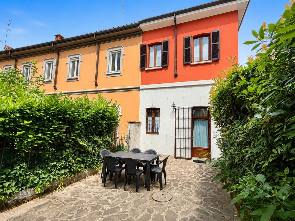 a table and chairs in front of a building at Rainbow District Mood Villa in Milan
