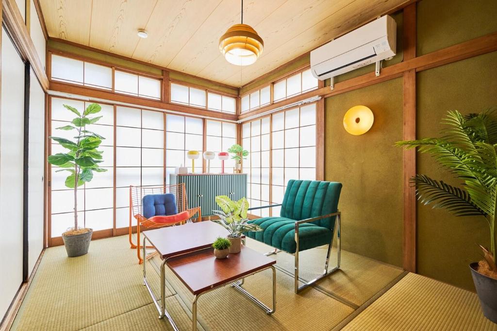a living room with two chairs and a table at Kokonimo Kawagoesenba in Kawagoe
