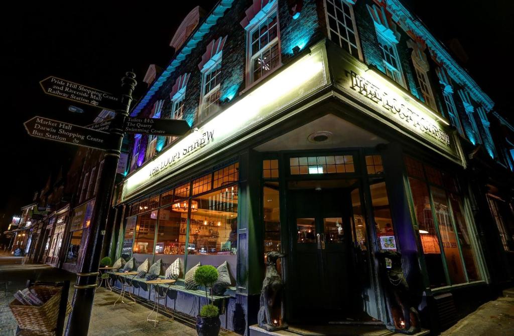 a store front of a building on a street at night at The Loopy Shrew in Shrewsbury